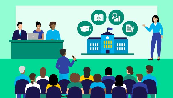 A person giving a presentation in front of a seated audience, with a panel of participants on stage.